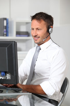 Closeup of businessman in the office with headphones