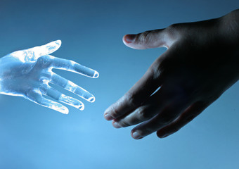 Human hand touch an atrifical glass hand