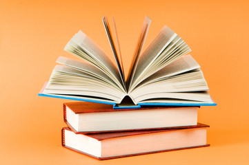 Fototapeta premium Stack of books on the color background