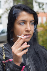 Fototapeta na wymiar Girl smoking outdoors