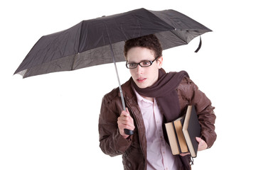 Young boy with an umbrella carrying books