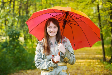 girl with umbrella in autumn park