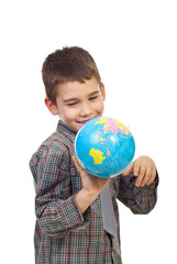 Preschool boy playing with a globe