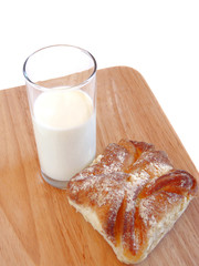Glass of milk and sweet roll