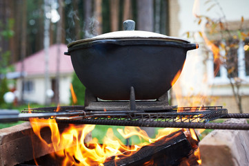 Pilaf cauldron with the lattice barbecue.