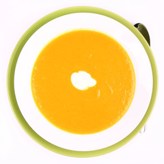 Pumpkin Soup decorated with cream on white background