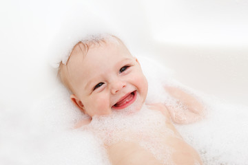 Joyful infant in bath