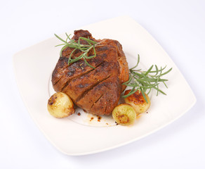 Roast pork with some onions and rosemary on a plate