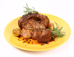 Roast pork with rosemary, onions and colorful peppercorns