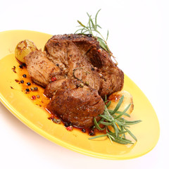 Roast pork with rosemary, onions and colorful peppercorns