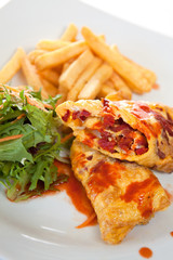 Stuffed crepes with salad and fries