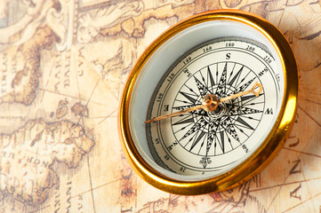 Old compass on ancient map