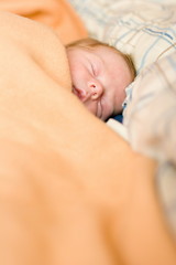 sleeping baby in big bed