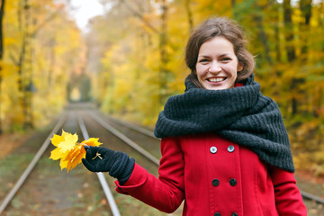 Young happy woman in autumn park
