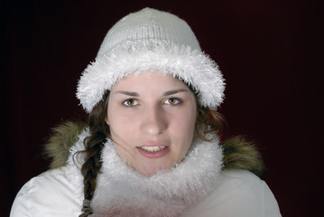 winter portrait of young woman with white bonnet