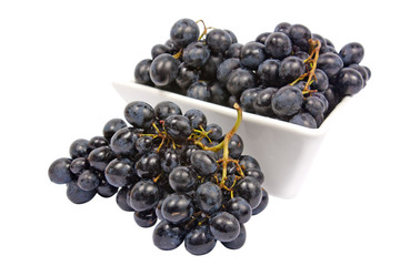A bowl of grapes isolated on white background