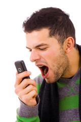Angry young man shouting at the phone. Isolated on white