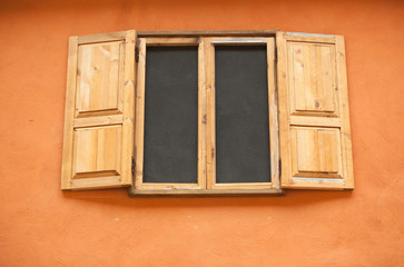 Vintage window on orange wall