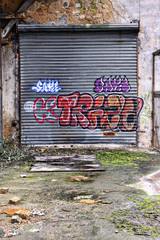 Rolling door covered with graffiti in an abandoned warehouse