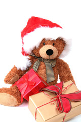 Teddy mit Weihnachtsmütze und Geschenken