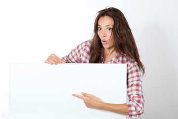 Woman showing white board on white background