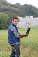 Engineer standing in front of dam under construction