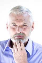 Senior man portrait pensive suspicion