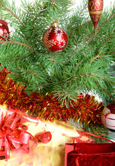 fur-tree branches, a tinsel and a gift box