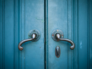 Door handles on blue door
