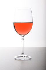Closeup of glasses full of wine on grey background