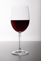 Closeup of glasses full of wine on grey background