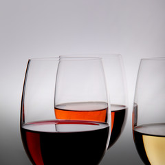 Closeup of glasses full of wine on grey background