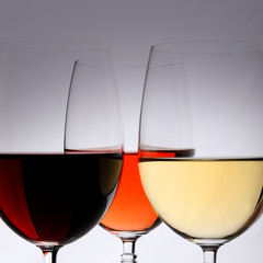 Closeup of glasses full of wine on grey background