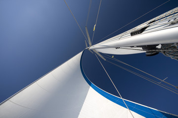 Sails and mast in the blue sky - Powered by Adobe