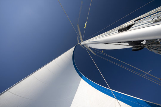 Sails and mast in the blue sky