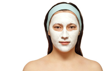 portrait of a young woman with beauty mask on her face isolated