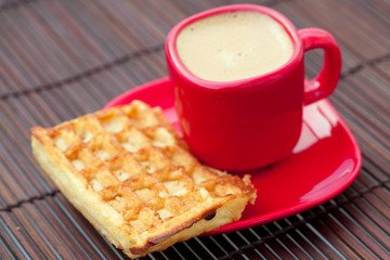 waffles and cappuccino on a bamboo mat