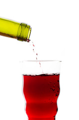 red wine pouring into glass isolated
