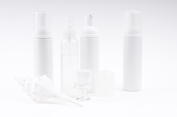 cosmetic bottles with brush and shell
