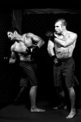 Fototapeta na wymiar MMA - Mixed martial artists fighting - punching