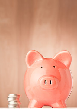 Piggy bank and coins on an abstract background