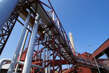 Fototapeta na wymiar Industrial zone, Steel pipelines and valves against blue sky