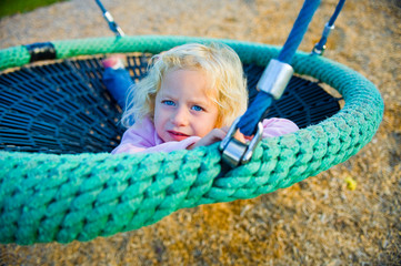 little girl in a swing