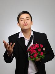 Happy romantic husband holding rose flower and vine bottle prepa