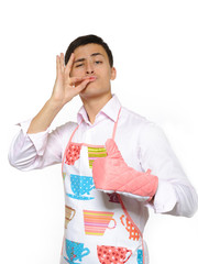 Young happy cook man in apron smiling and leathing. isolated on