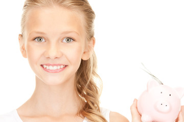lovely teenage girl with piggy bank and money