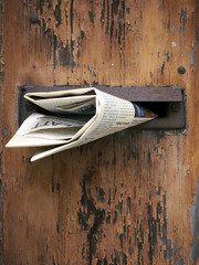 Wooden mailbox with newspaper