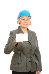 Senior woman with blue hard hat holding blank sigh