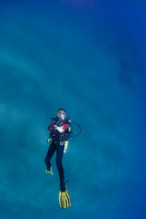 Female scuba swimming on her back