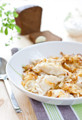 Potato dumplings served with fried onion